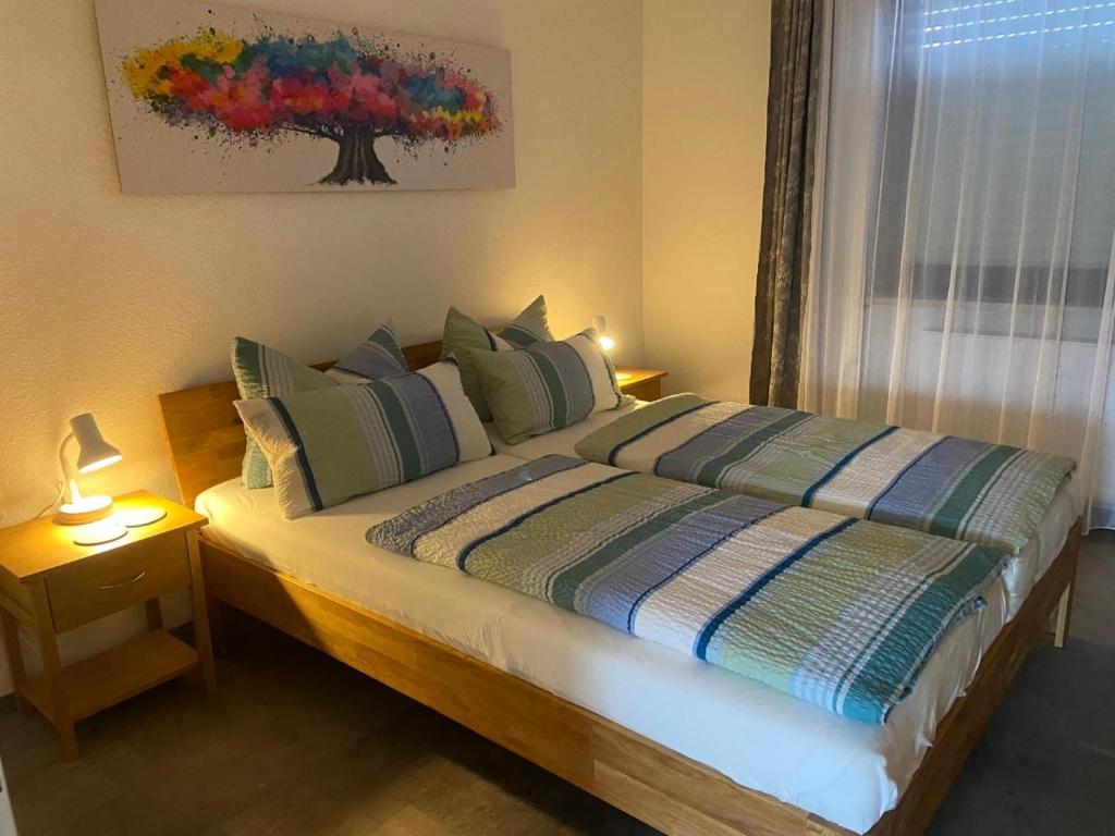 a bedroom with a bed with two lamps and a window at Ferienwohnung Fein in Bad Sachsa