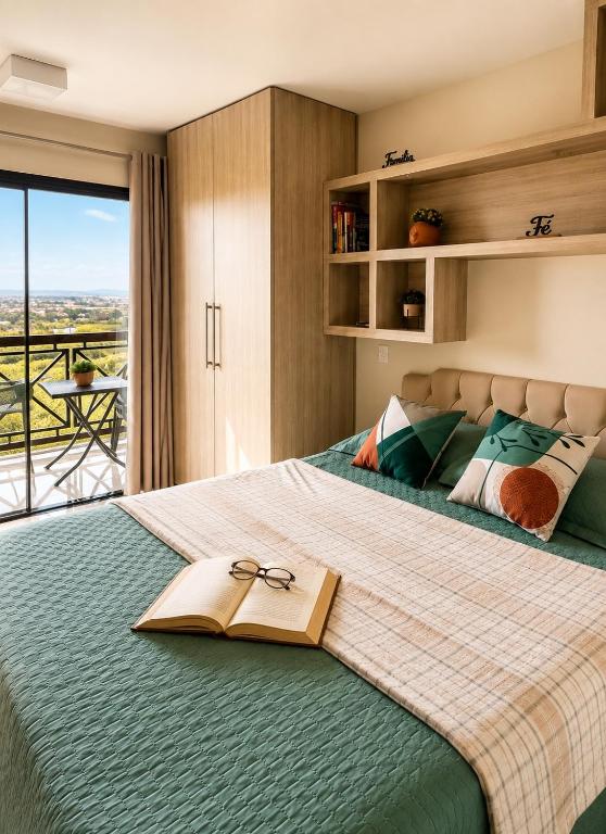 a bedroom with a bed with a book on it at Flat Monte Castelo ,Vista Incrível,Conforto in Sairé