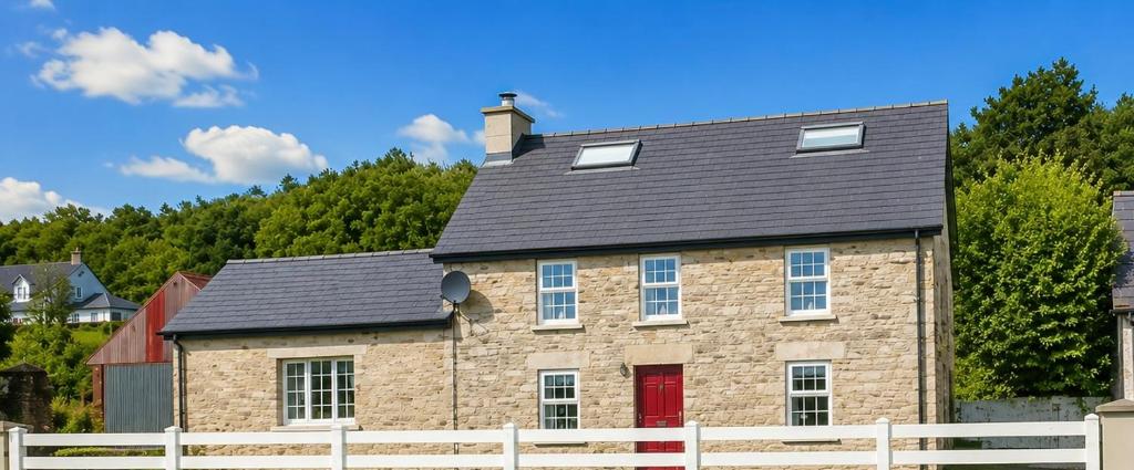 a large brick house with a black roof at Donegal Cottage in Inver