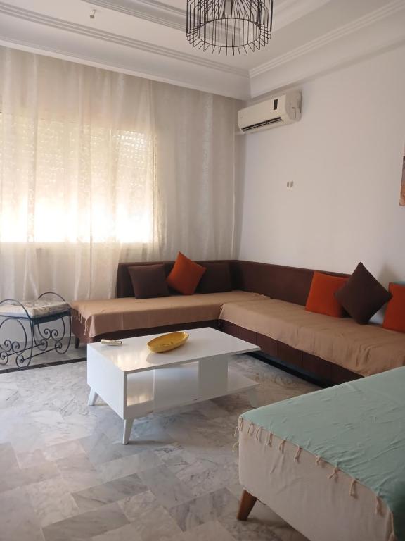 a living room with a couch and a coffee table at galaxy home in Nabeul