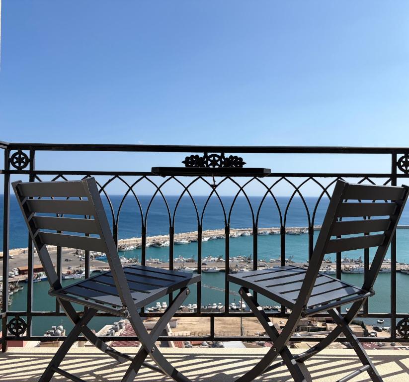 two chairs sitting on a balcony overlooking the ocean at Domus Maris Relais Boutique Hotel in Sciacca