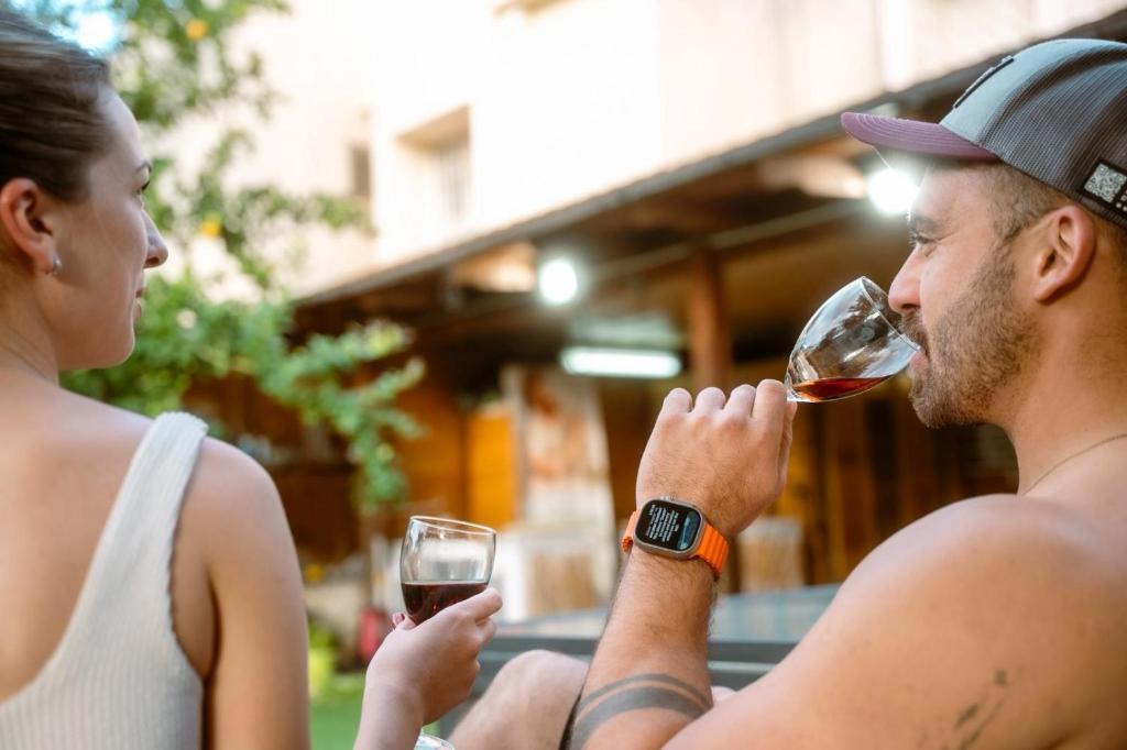 a man and a woman drinking wine from wine glasses at Green therapy - Wellness resort in Bet Dagan