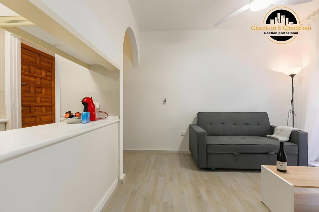 a living room with a couch and a table at El Bajondillo Apartment in Torremolinos