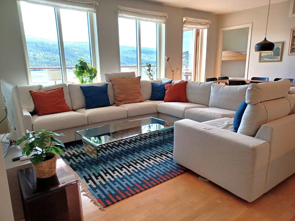 a living room with a white couch and a glass table at Lakeview 4BR with Sauna & EV Parking in Åre