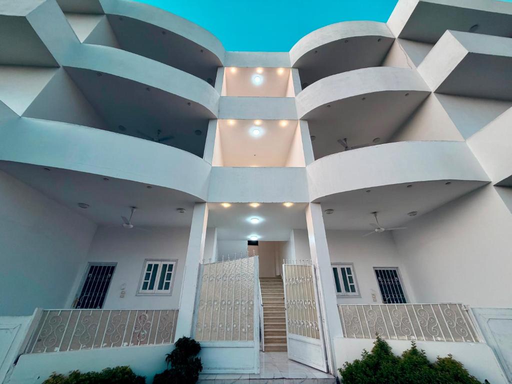 a large white building with a large ceiling at Star - private apartments in Luxor