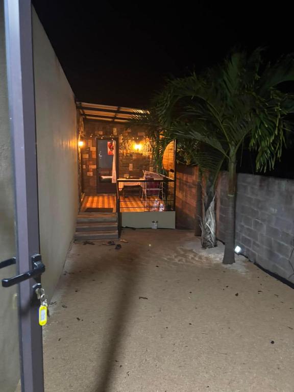 a hallway of a house at night with a table at House - Maison Blue Print- 2 bedrooms in Surinam