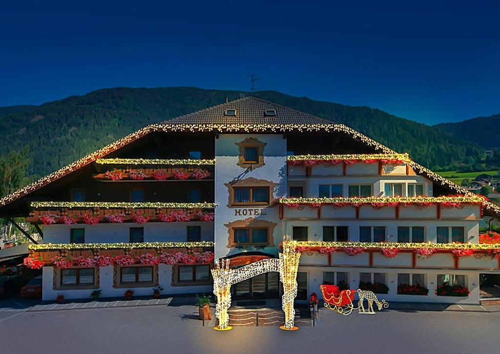 a large building with a giraffe decorations on it at Hotel Kronplatzer Hof in Rasun di Sopra