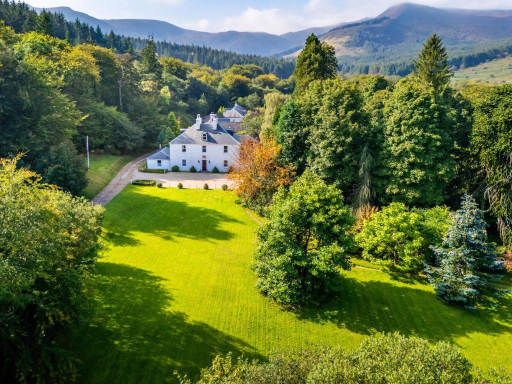 an aerial view of a house in the middle of a green field at Kilmichael House in Brodick