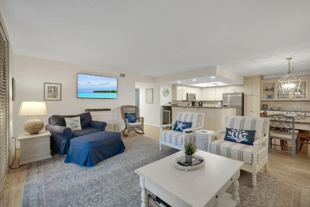 a living room with a couch and a table at Compass Point 221 in Sanibel
