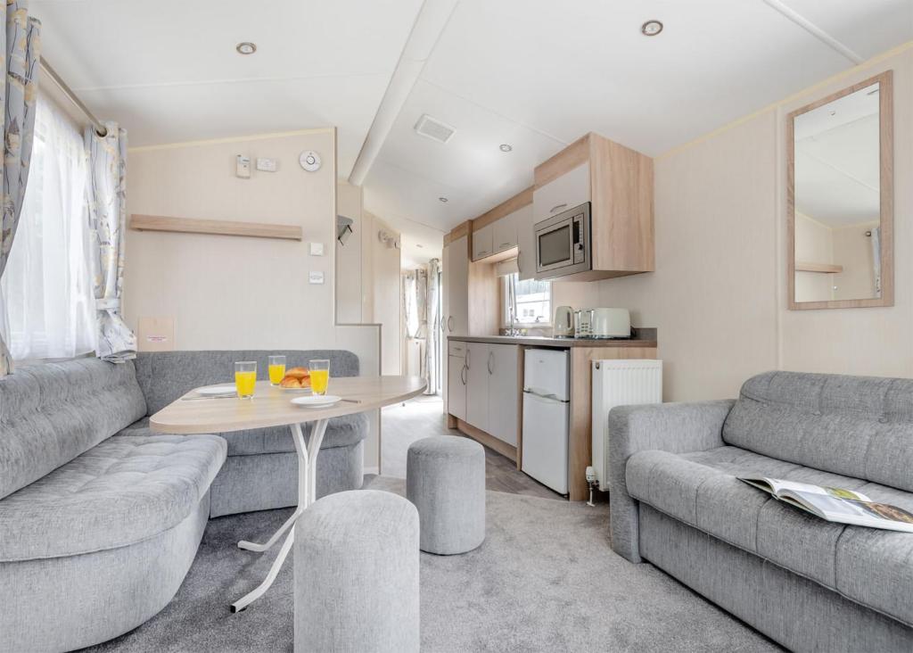 a living room with a couch and a table at Lower Hyde in Shanklin
