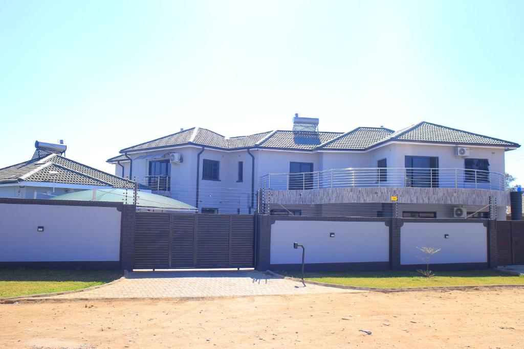 a large house with two garage doors in front of it at Brooke Paradise in Bulawayo