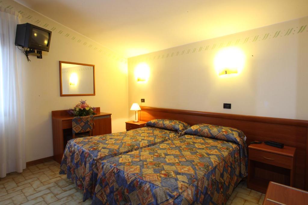 Łóżko lub łóżka w pokoju w obiekcie Albergo Alla Campana