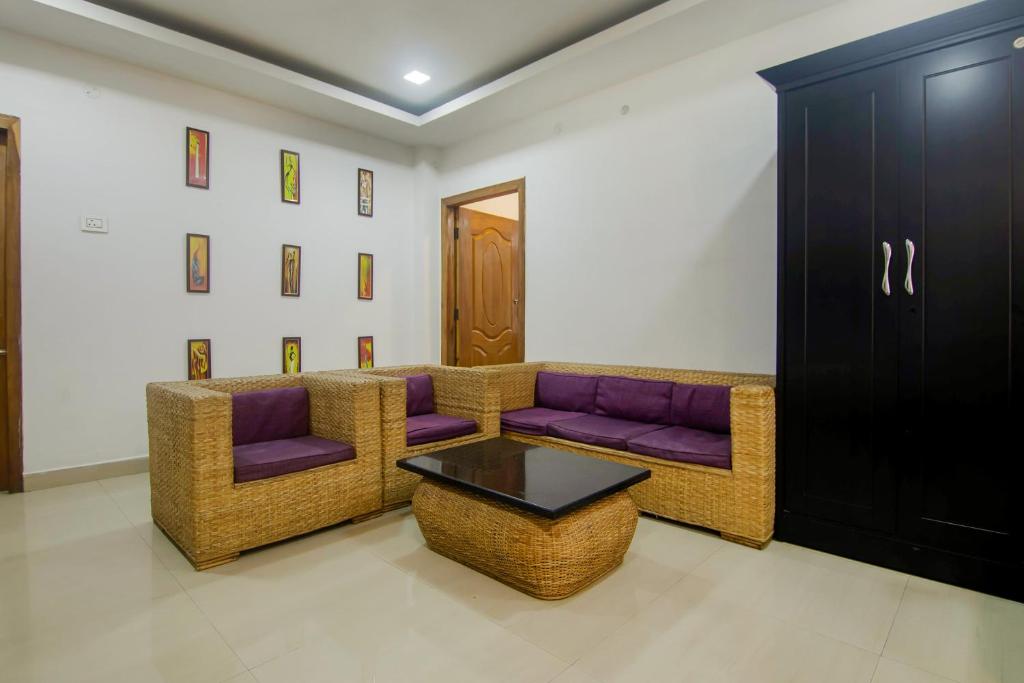 a living room with a couch and a table at Hotel OThe Blu Bell in Guwahati