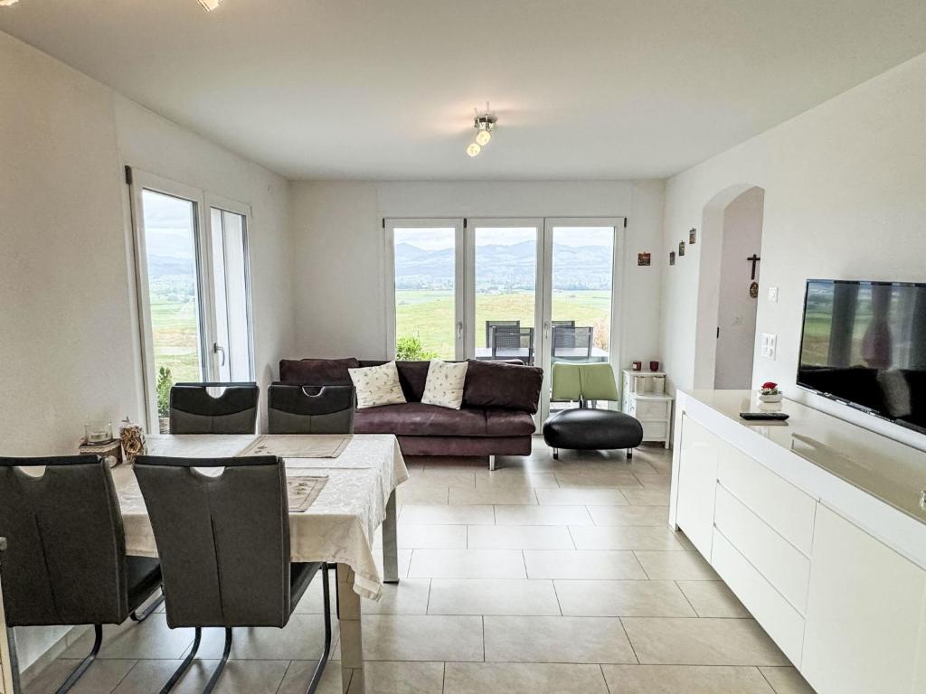 a living room with a table and a couch at Apartment Luxenweid by Interhome in Reichenburg