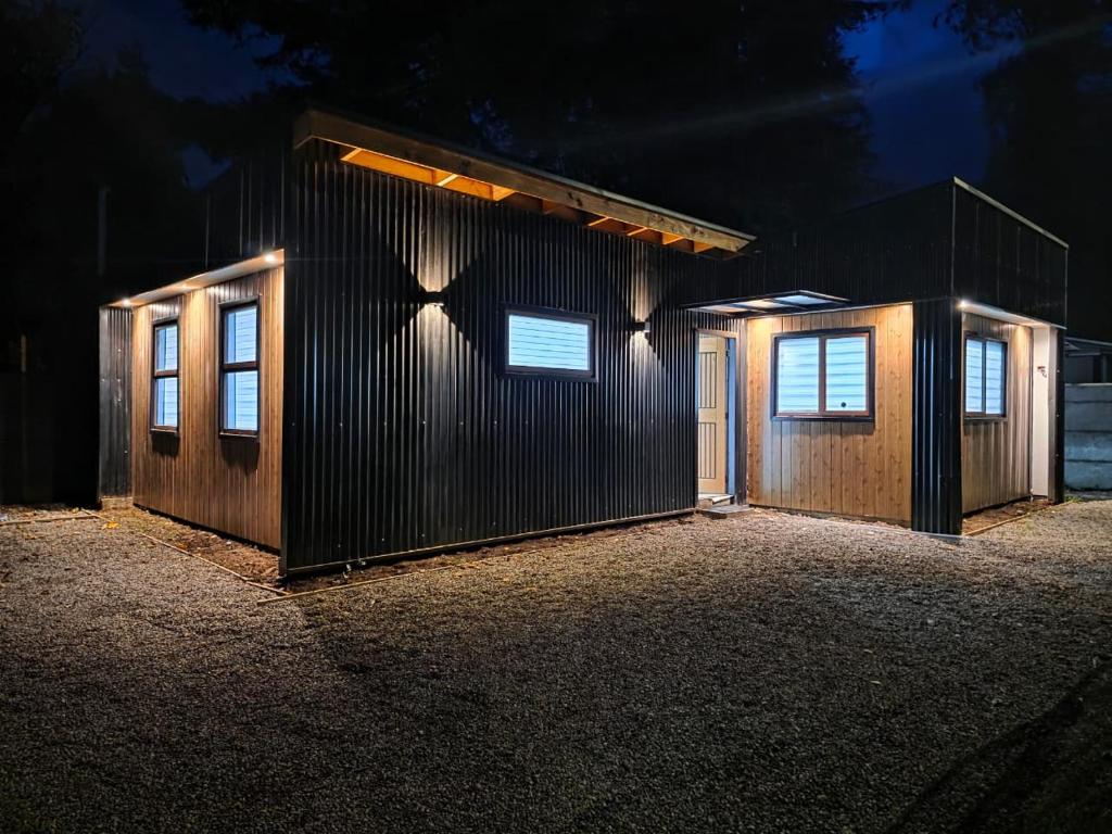 a building with three doors on the side at night at Casa en Lanco in Lanco