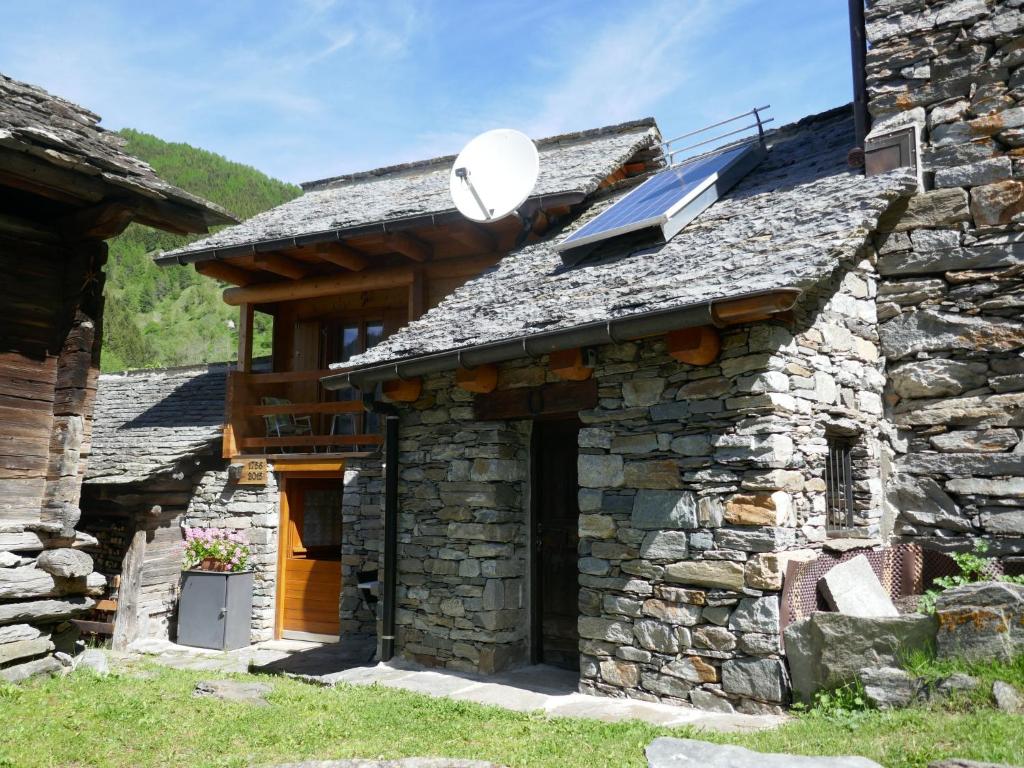 an external view of a stone house with a solarium at Holiday Home Rustico Nurell by Interhome in Madra