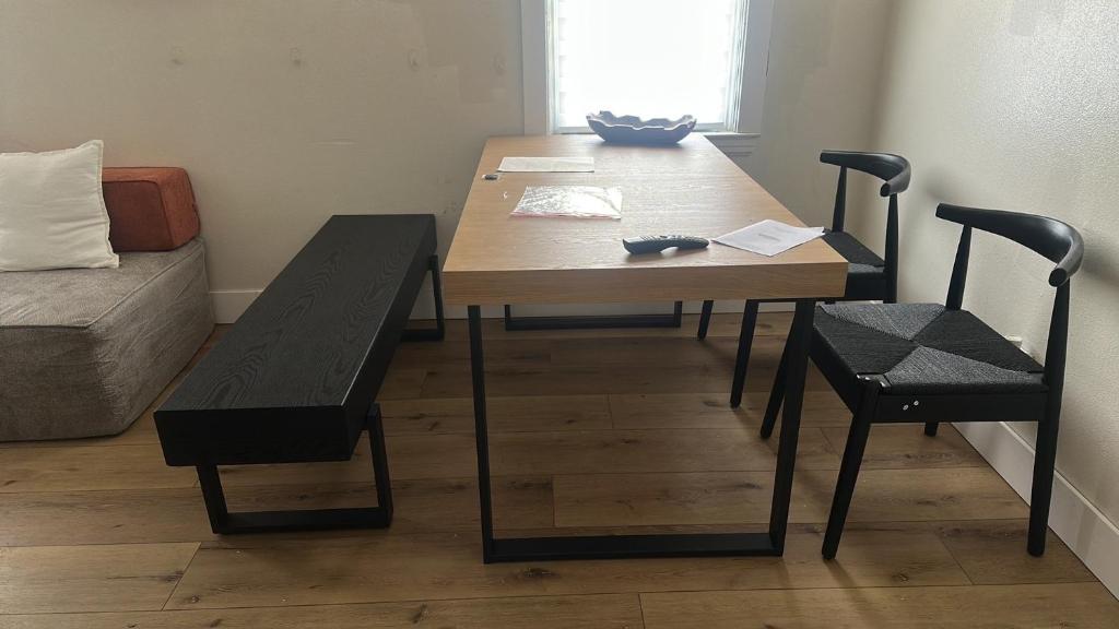 a dining room table and chairs in a room at Comfortable Private Room Shared Bathroom in Vinita Park