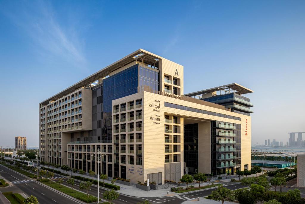 a large office building in the middle of a city at Bloom Arjaan by Rotana in Abu Dhabi