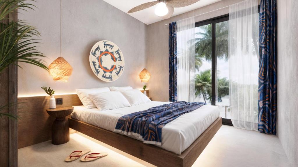 a bedroom with a bed and a large window at Cocco Lagoon Resort & SPA 