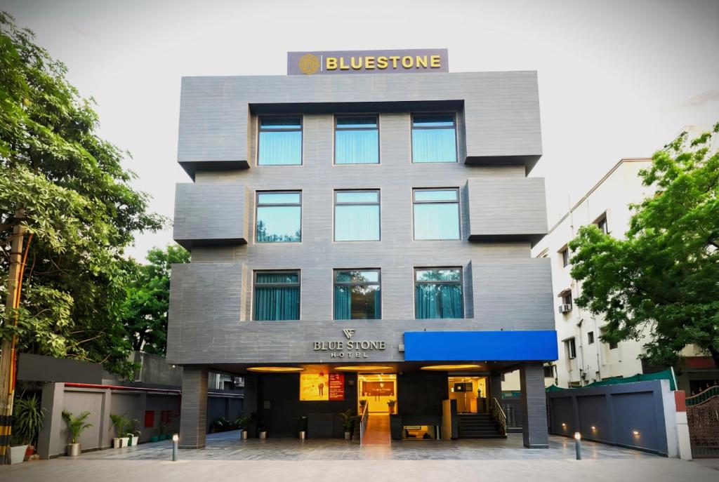 a building with a sign on the front of it at Bluestone Nehru Place by The Cosy Hotels in New Delhi
