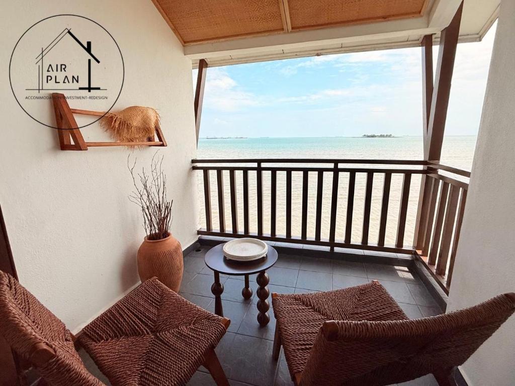 a room with a balcony with a view of the ocean at PD Full Seaview Water Chalet with Private Bathtub in Port Dickson
