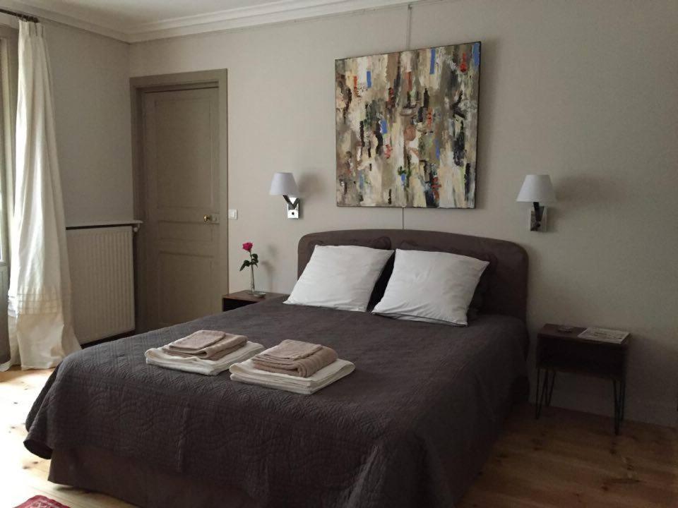 a bedroom with a bed with two towels on it at 1 Square du Docteur Blanche - Paris 16 in Paris