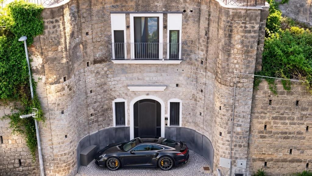 a black car parked in front of a building at La Torre di LuSi in Castellammare di Stabia