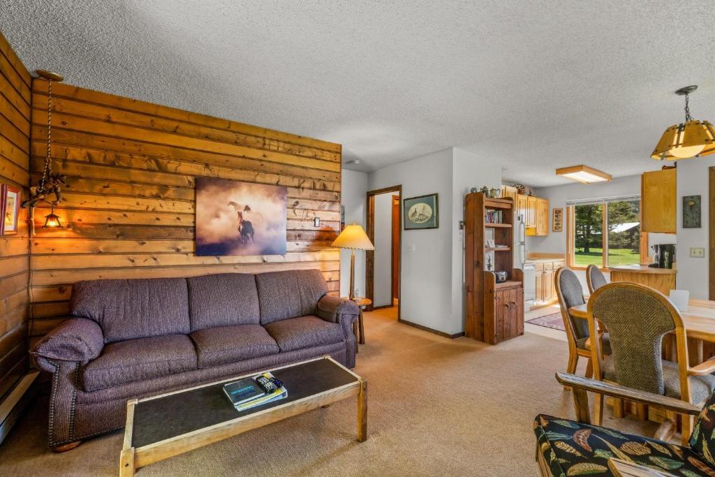 a living room with a couch and a table at Wood Duck in Clark
