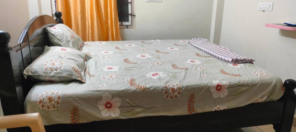 a bed with a blanket and pillows on it at Sri varahi rest house in Avanigadda