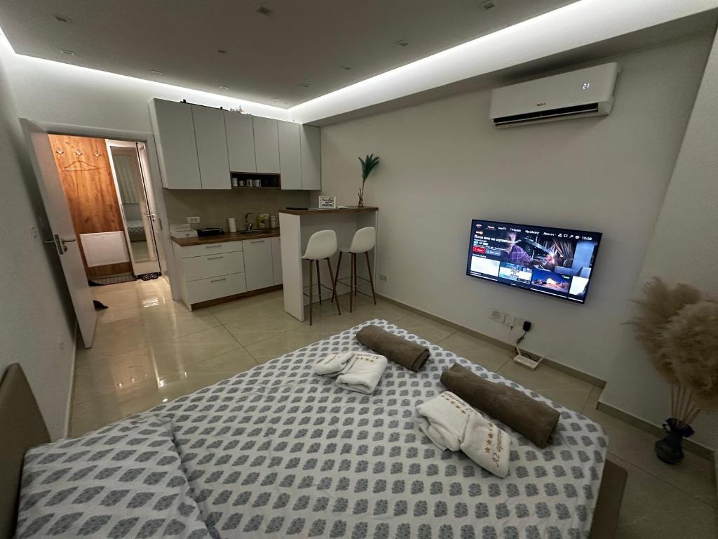 a bedroom with a bed and a tv on the wall at A2 Apartment in Gostivar
