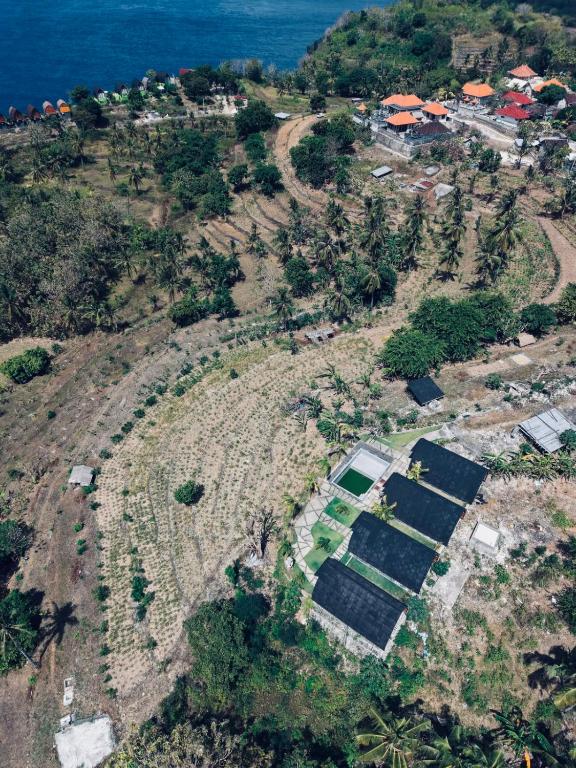 an aerial view of an island with solar panels at The Southeast Penida in Polilit