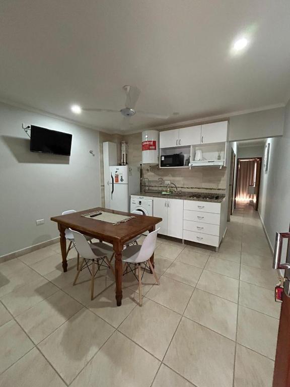 a kitchen with a table and chairs in a room at ALOJAMIENTO NORTE SGO in Santiago del Estero