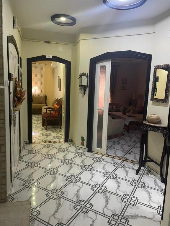 a living room with a tile floor and a living room at Apartment - Jijel in Jijel