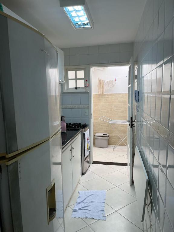 a kitchen with a sink and a stove at Casas Arraial in Arraial do Cabo