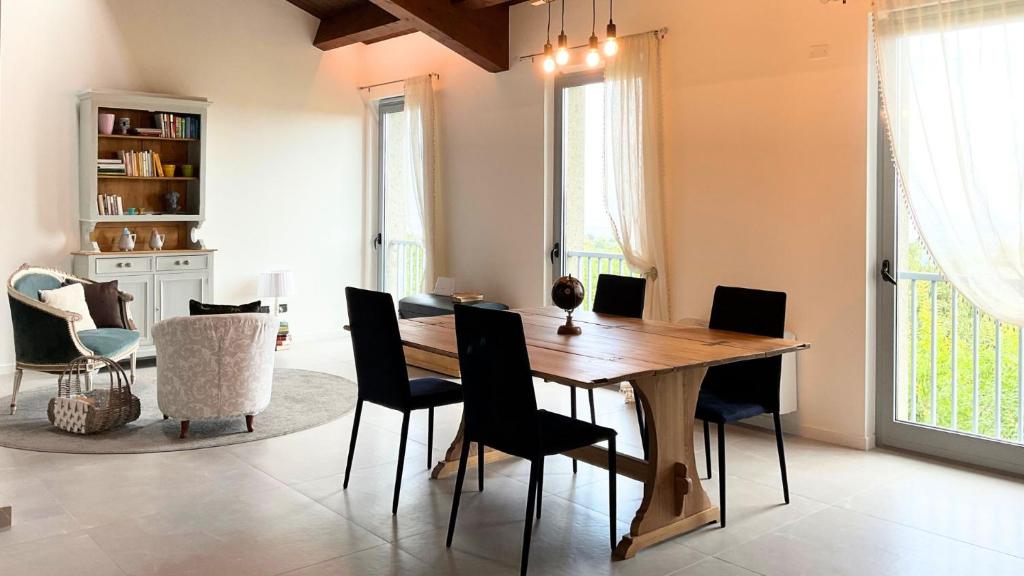a dining room with a wooden table and chairs at Deltasol in Montepulciano