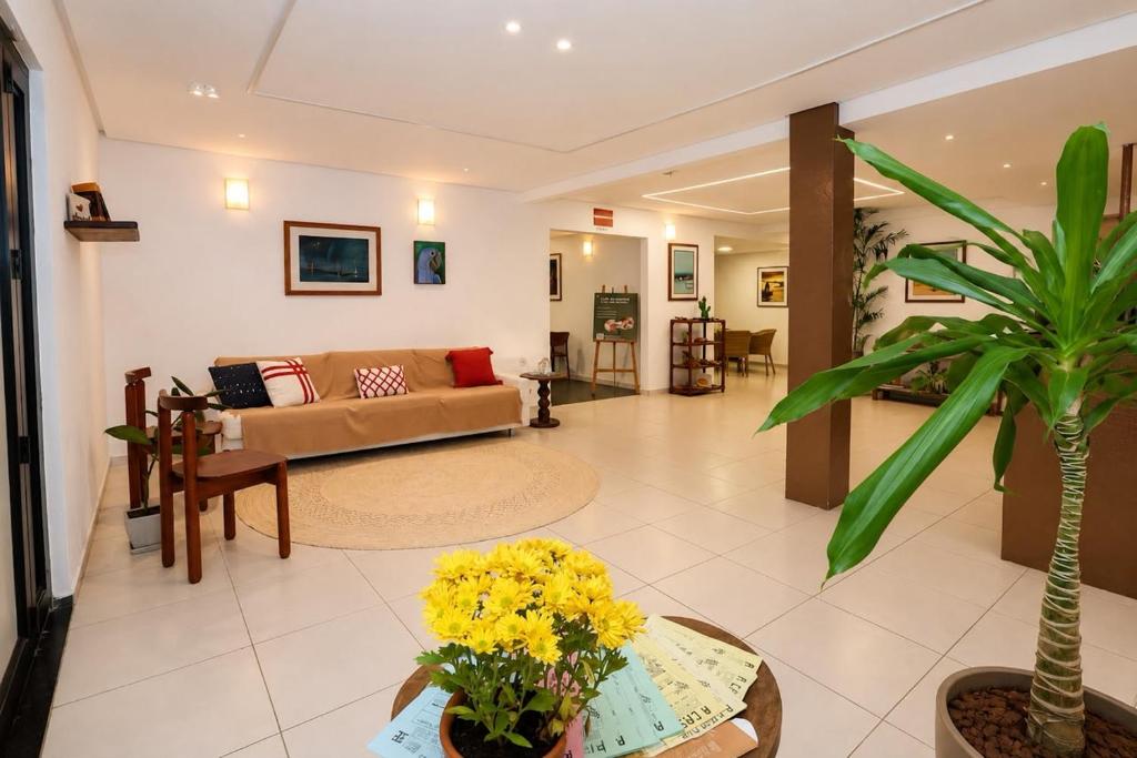 a living room with a couch and a table at Pousada Mangaba Sergipe in Aracaju