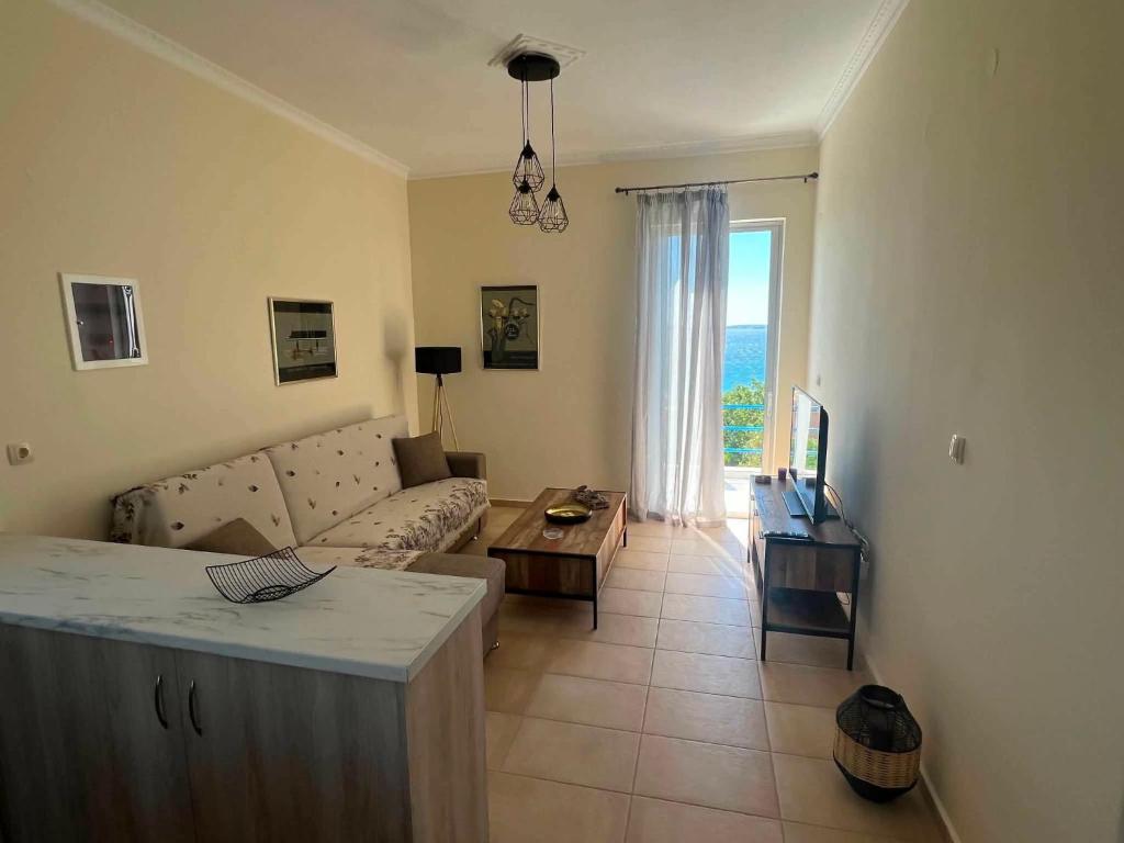 a living room with a couch and a table at Karfas Seascape in Chios