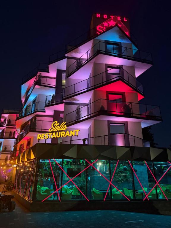 a building with a neon sign on the side of it at Stella in Ternopil