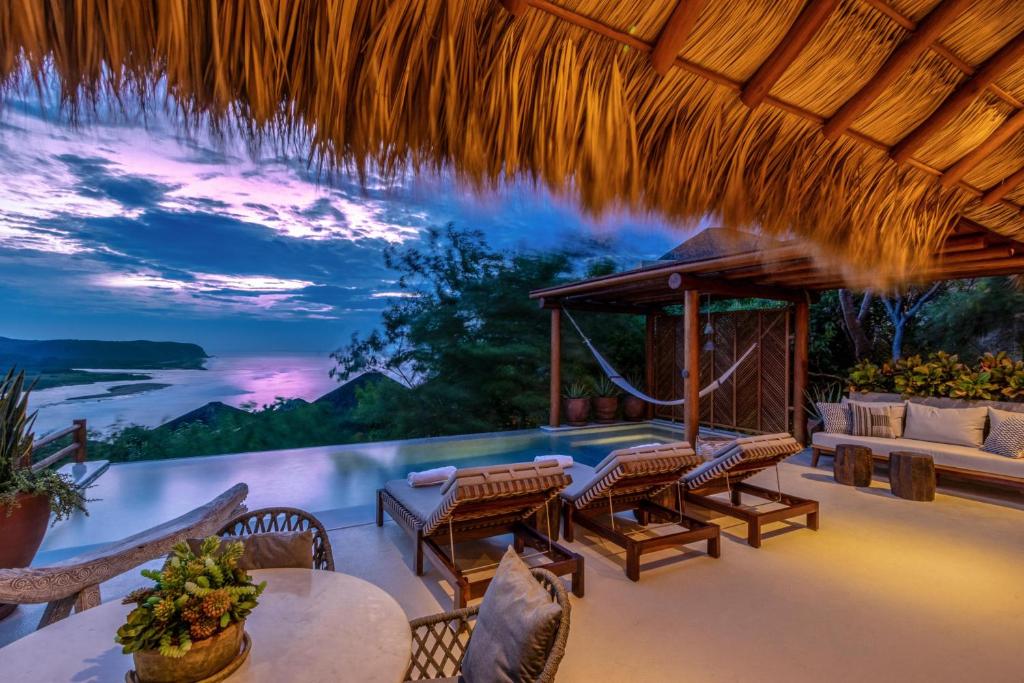 a resort patio with a view of the water at 3068 - Villa Soleri in Valerio Martínez