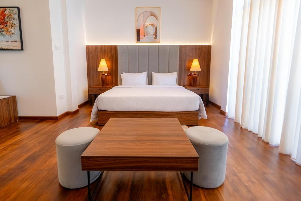 a hotel room with a bed and a table at Riverdale lagoon villas in Aluthgama