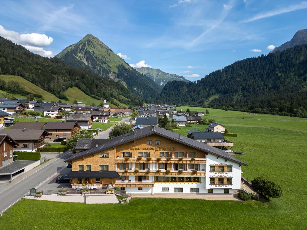 a hotel in a valley with mountains in the background at Hotel Elisabeth in Schoppernau