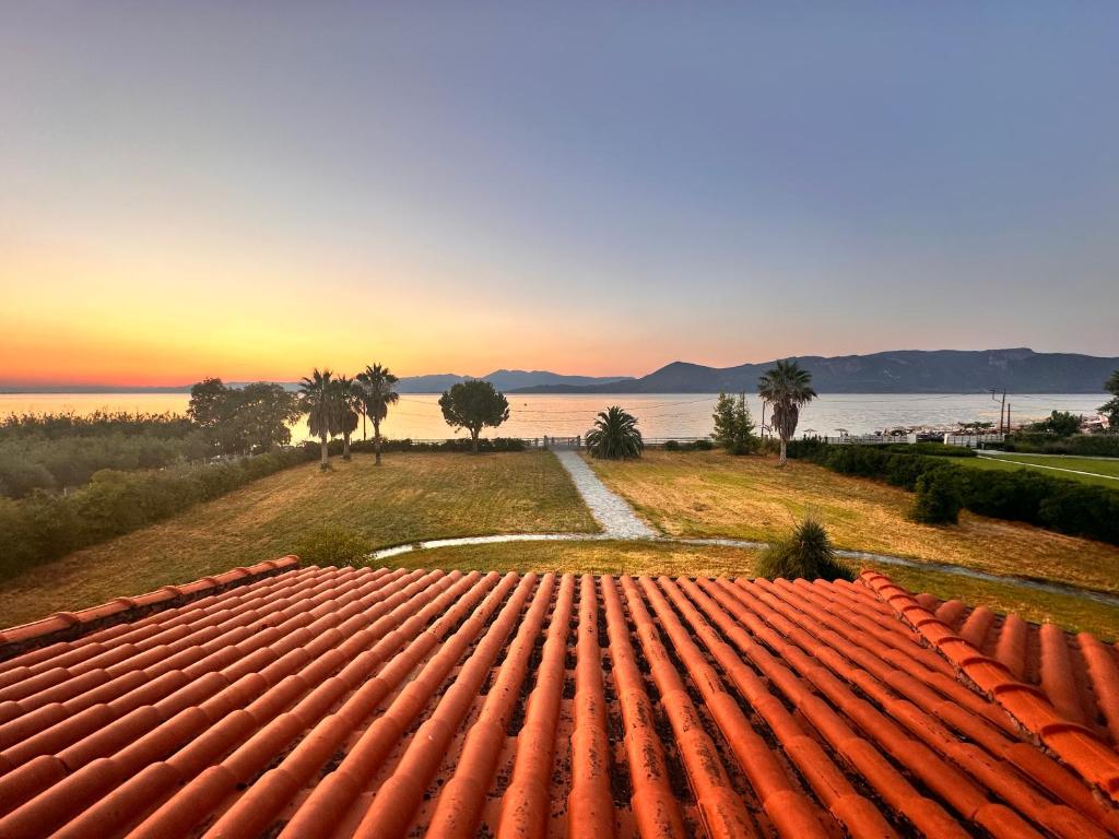 a view from the roof of a house at sunset at Beachfront Villa Tranquility in Longós
