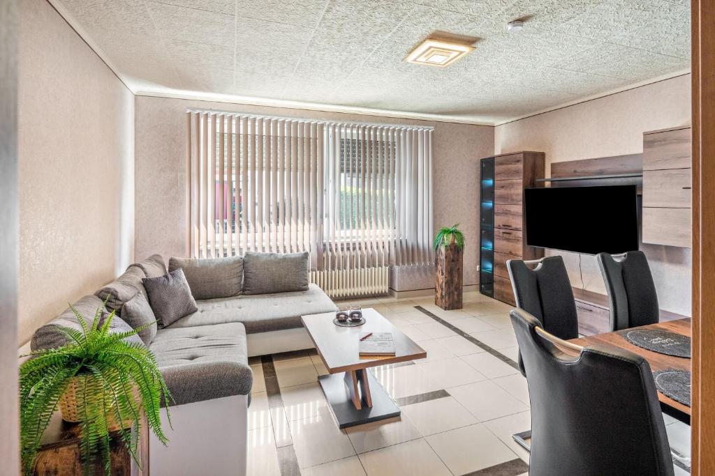 a living room with a couch and a table at Land Leben Wohnung 1 in Erkelenz