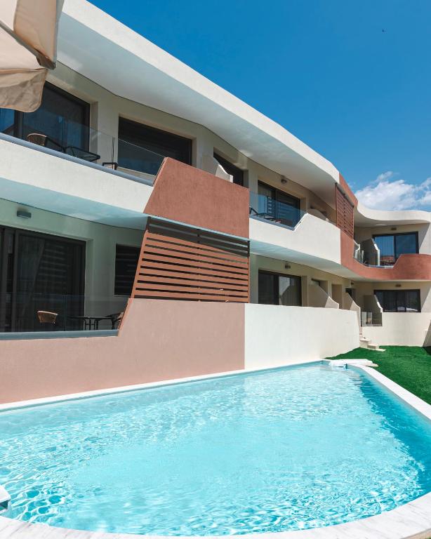 a swimming pool in front of a house at The Wave in Limenaria
