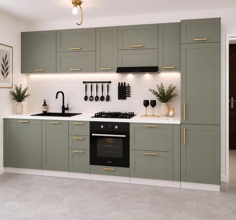 a kitchen with green cabinets and a sink and a stove at Delux Apartament in Haţeg