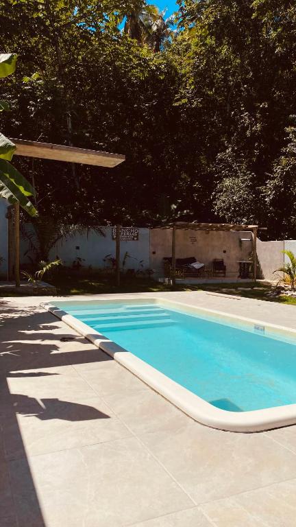 an empty swimming pool in a yard with trees at Rancho de férias in Japaratinga