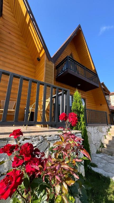 a house with red flowers in front of it at Dilijan Tun Boutique Hotel in Dilijan