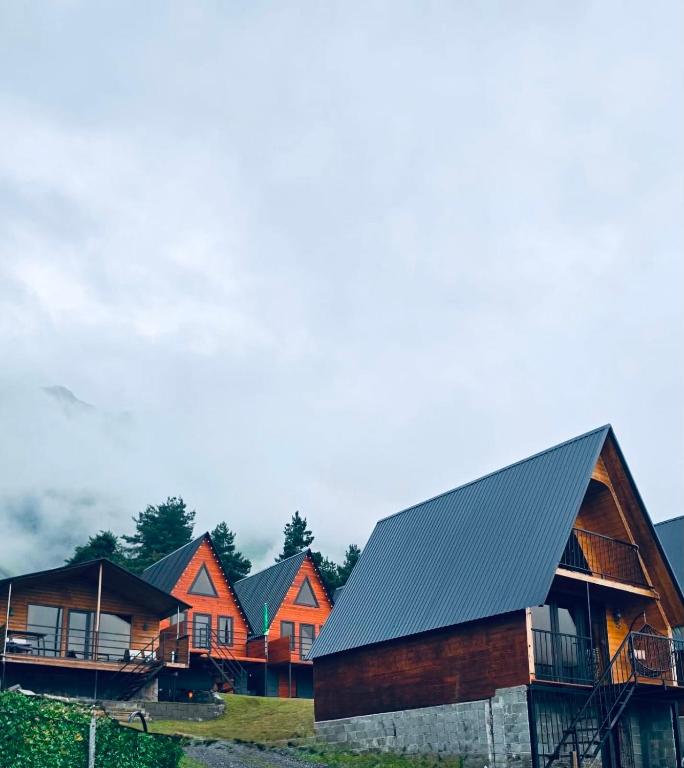 a row of houses with orange and gray roofs at Elia Hut Kazbegi in Kazbegi