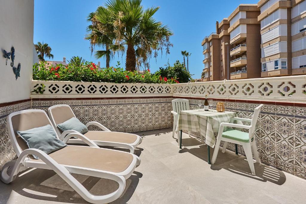 a patio with chairs and a table on a balcony at Casita Helena in Torrox