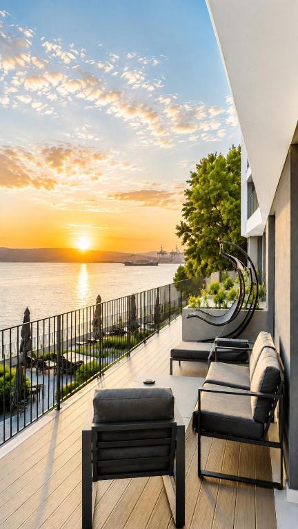 a balcony with couches and a view of the water at VILA MOLET KOPER in Koper